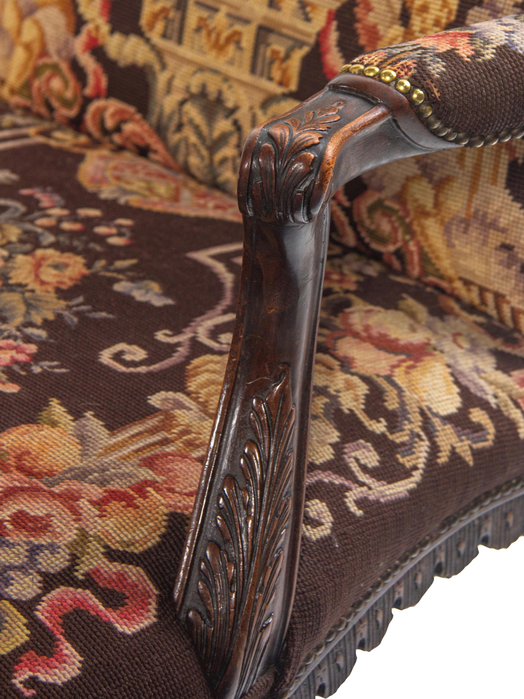 A George II Style Carved Mahogany Armchair with Needlepoint Upholstery