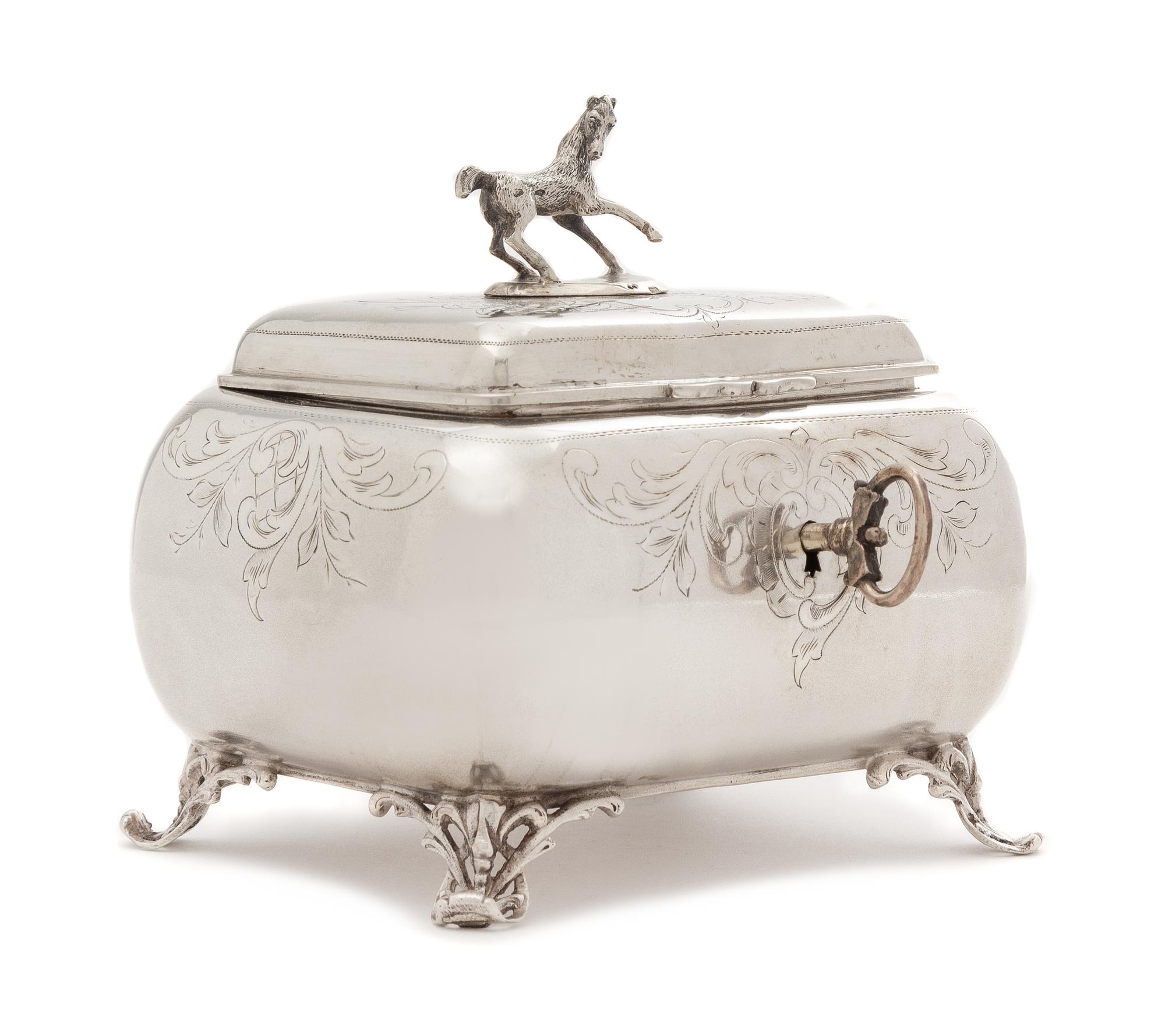 An Austrian Silver Tea Caddy, Maker's Mark H.S., Vienna, Late 19th/Early 20th Century, of lobed rectangular form, the lid with an appli