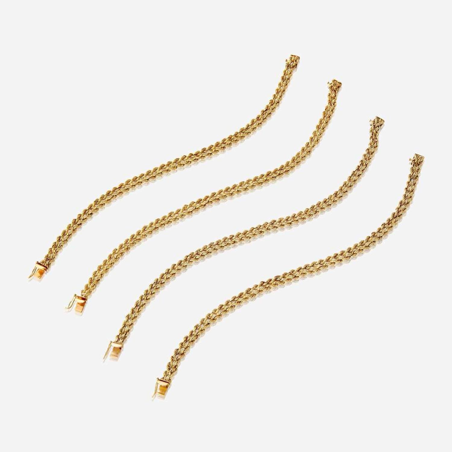 A collection of four eighteen karat gold bracelets