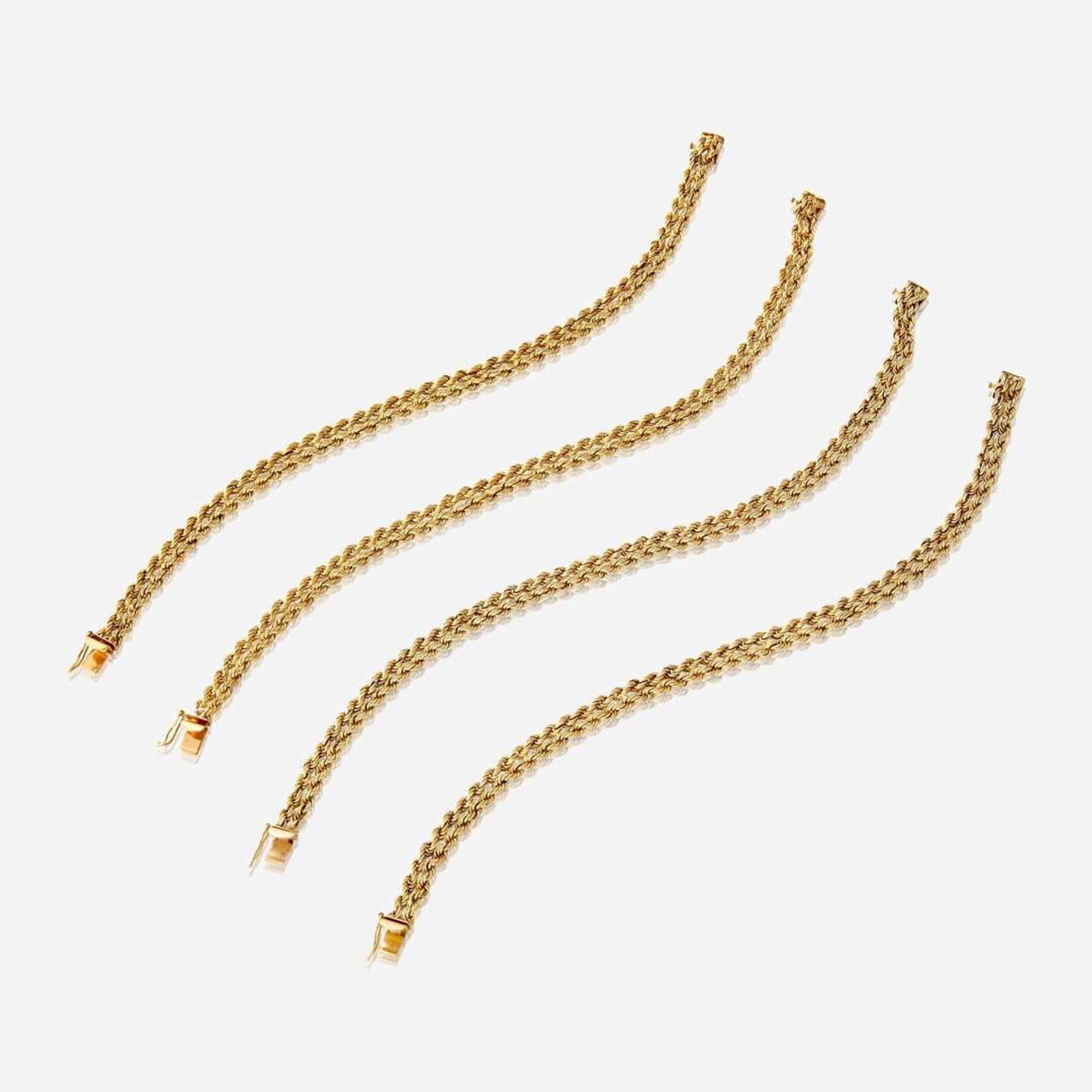 A collection of four eighteen karat gold bracelets