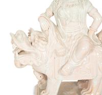 A Pair of Chinese Glazed Ceramic Figures of Guan Yin Atop a Foo Dog