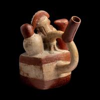 A Moche Stirrup Vessel in the Form of a Shaman with Two Anthropomorphic Figures