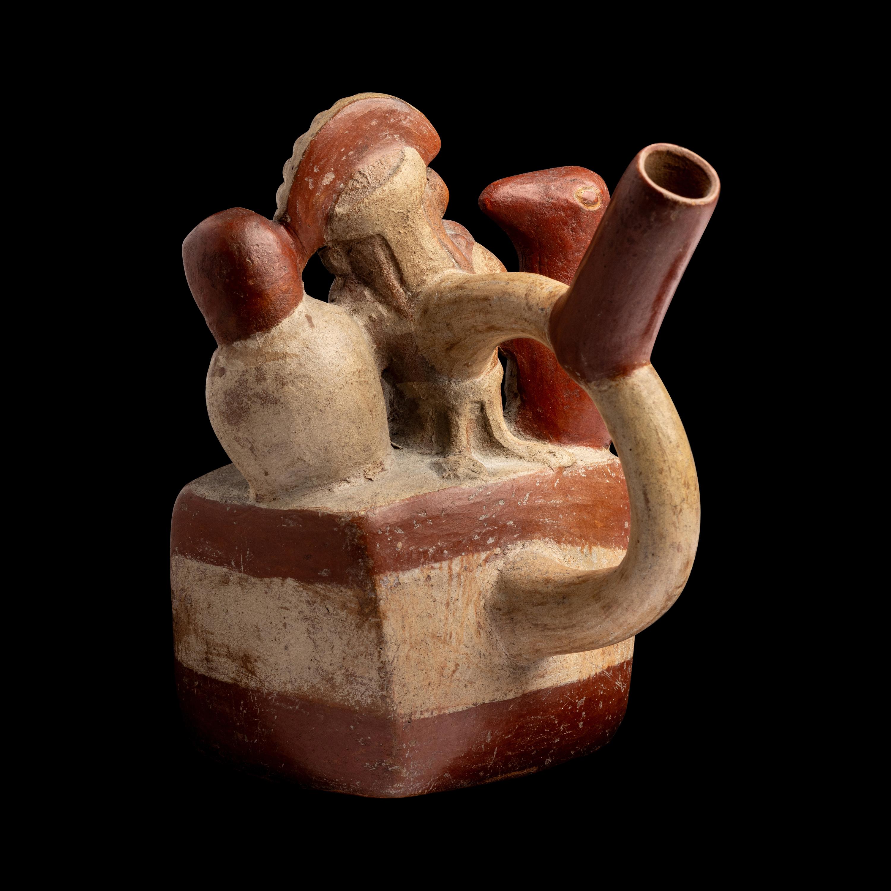 A Moche Stirrup Vessel in the Form of a Shaman with Two Anthropomorphic Figures