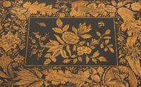 A Regency Black and Gilt Lacquer Box on Brass Paw Feet