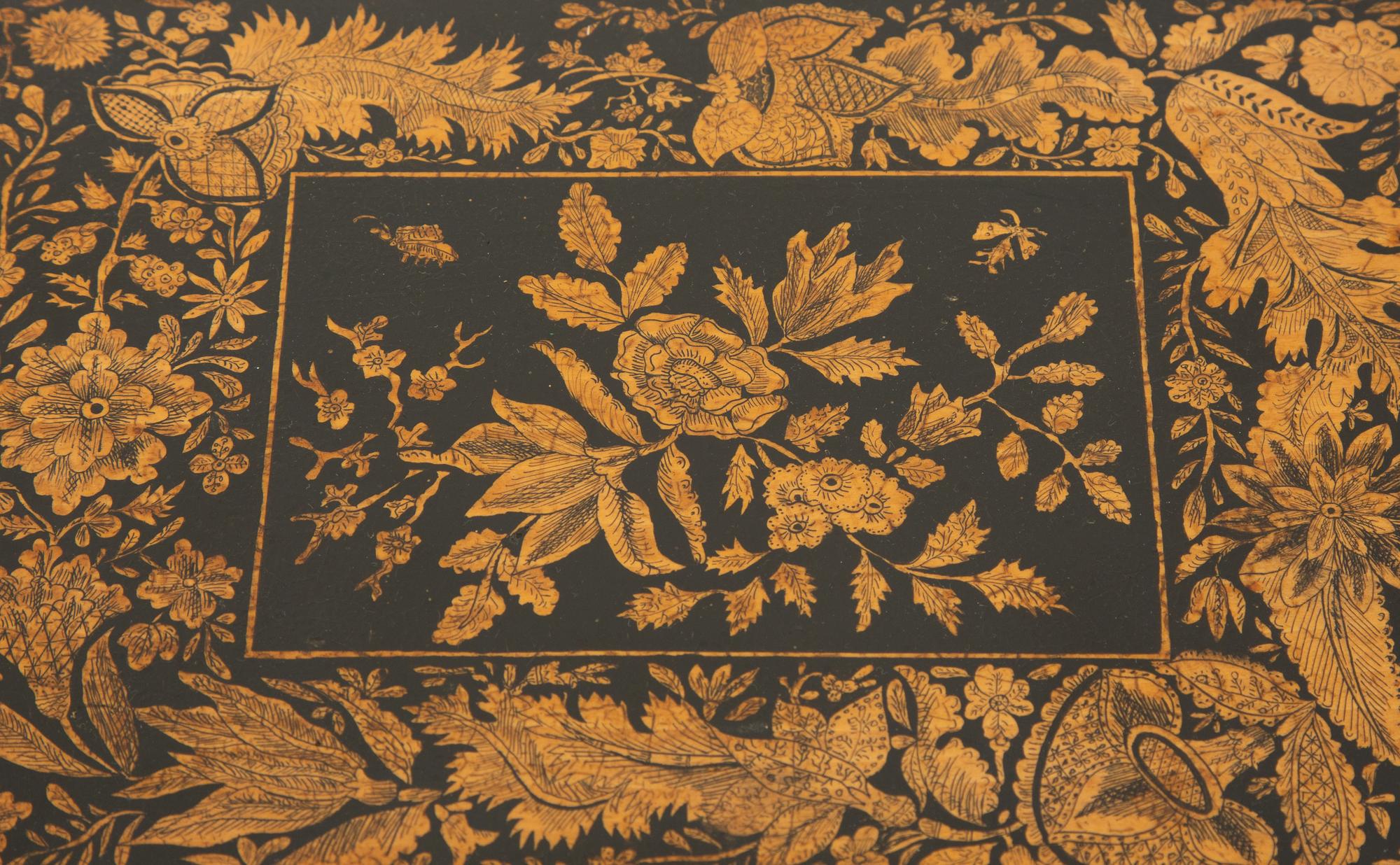 A Regency Black and Gilt Lacquer Box on Brass Paw Feet
