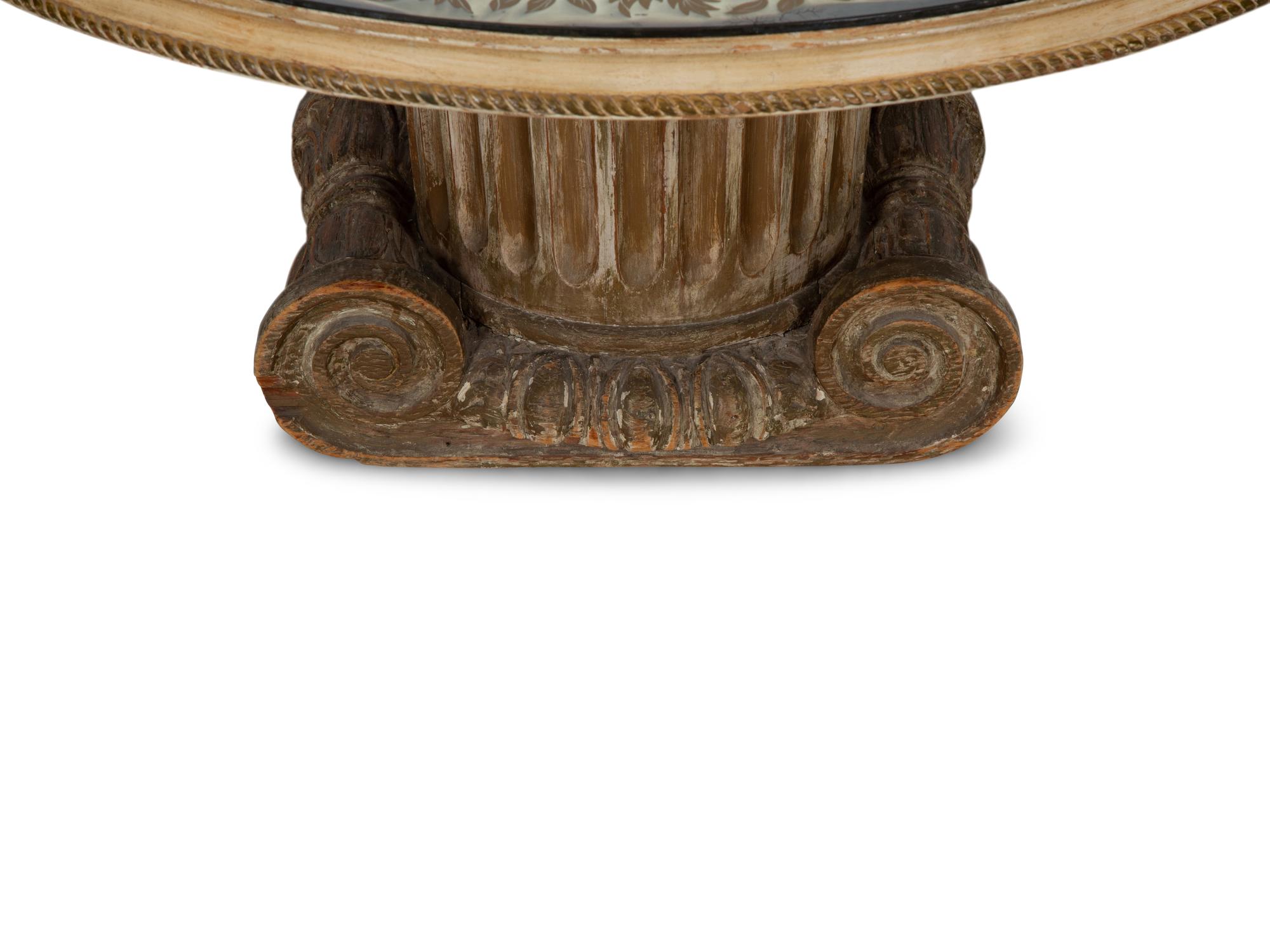 A Neoclassical Style Carved Wood Columnar Base Table with Gilt Decorated Smoke Glass Top