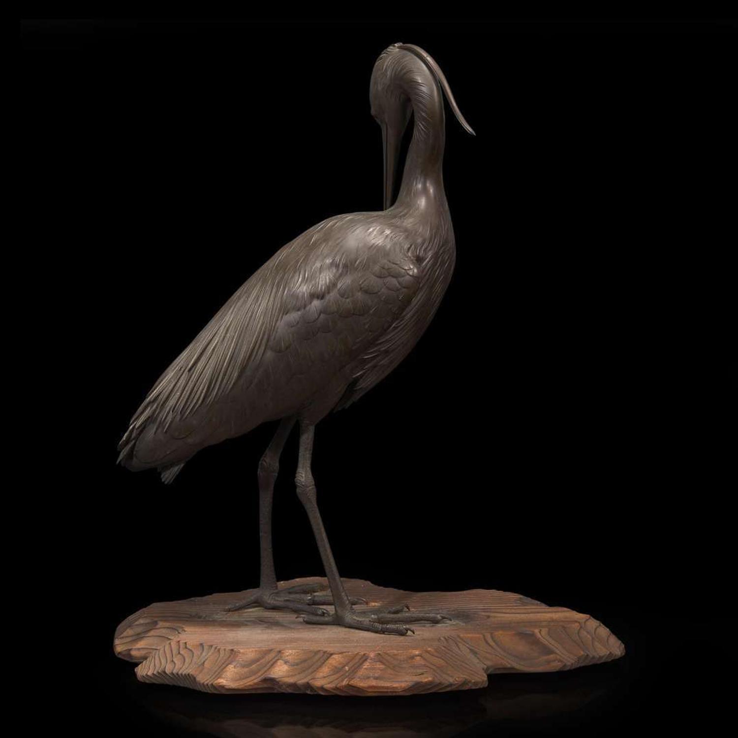 A Japanese patinated bronze figure of a preening heron, signed Kuniharu 日本鹭鸶铜塑 斉木 Meiji / Taisho ?????