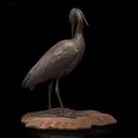 A Japanese patinated bronze figure of a preening heron, signed Kuniharu 日本鹭鸶铜塑 斉木 Meiji / Taisho ?????