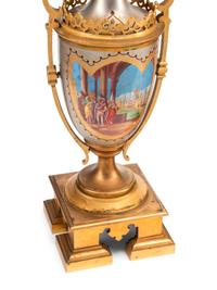 A French Gilt and Silvered Bronze and Porcelain Clock Garniture