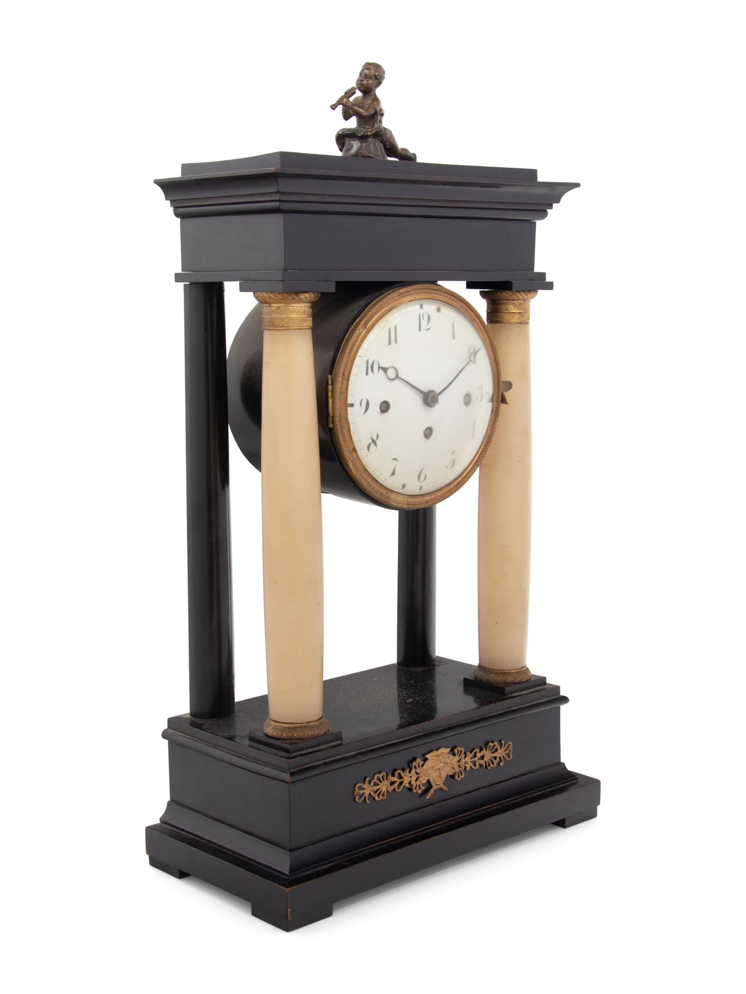 An Empire Style Gilt Metal and Alabaster Mounted Ebonized Clock