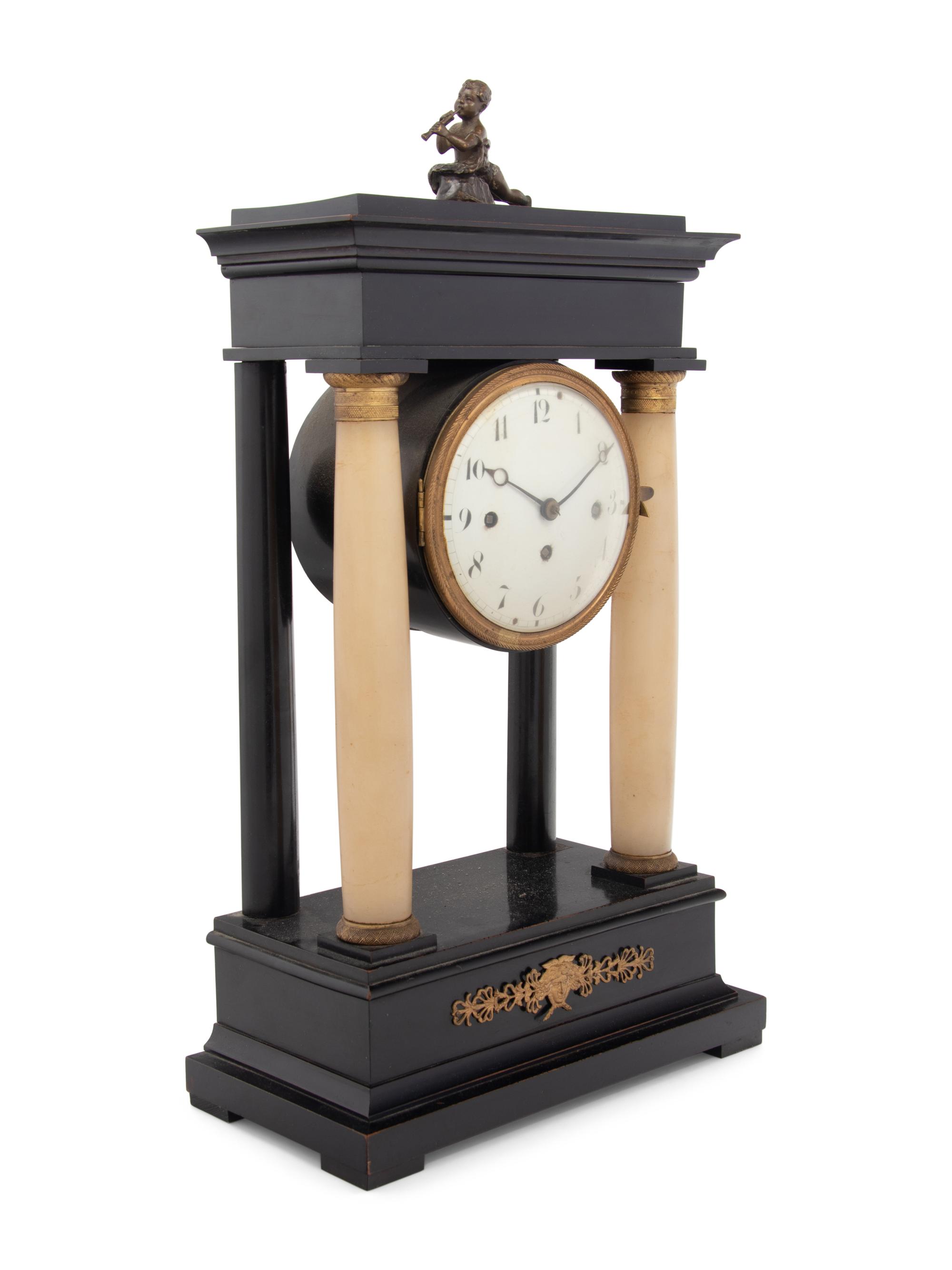 An Empire Style Gilt Metal and Alabaster Mounted Ebonized Clock