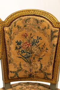 A Pair of French Neoclassical Painted and Parcel Gilt Armchairs