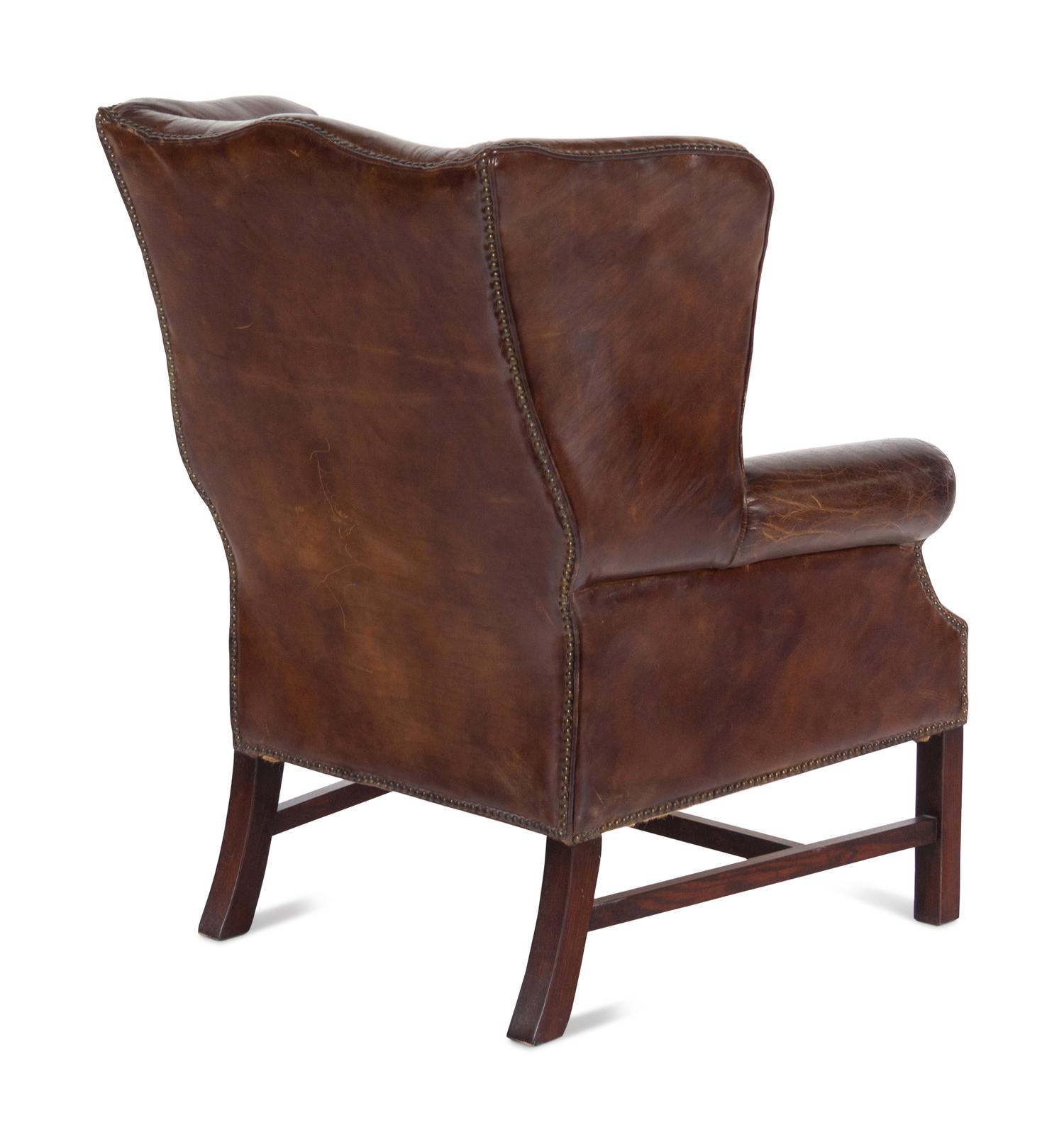 A Pair of Georgian Style Leather Upholstered Wingback Armchairs