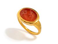 A Roman Carnelian Ring Stone with the God Silenus Surprising a Sleeping Woman — Set in a gold ring