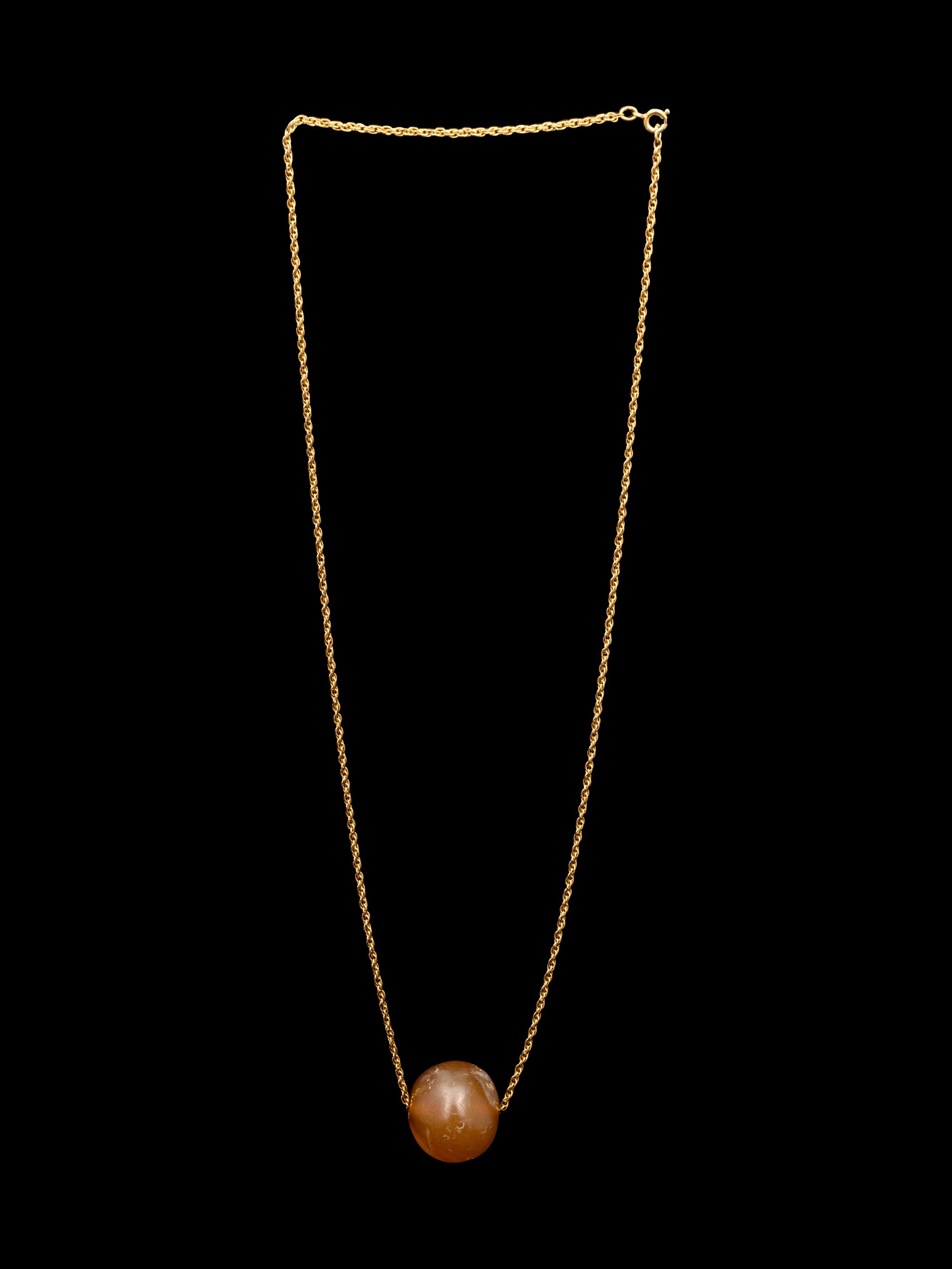 A Neo-Babylonian or Graeco-Persian Smokey Chalcedony Conoid Seal Necklace
