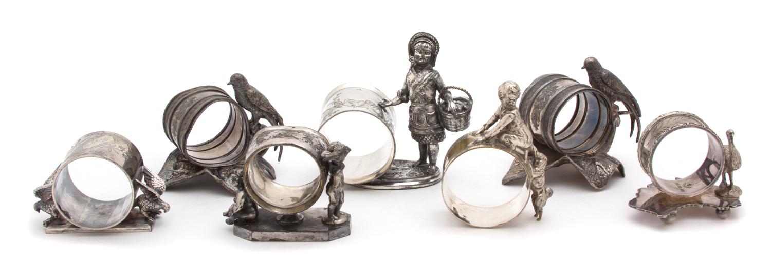 A Collection of Seven Silver Plate Napkins Rings Height of tallest 3 5/8 inches. — 19TH CENTURY