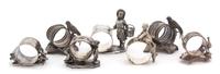 A Collection of Seven Silver Plate Napkins Rings Height of tallest 3 5/8 inches. — 19TH CENTURY