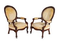 A Pair of Rococo Revival Carved Walnut Fauteuils