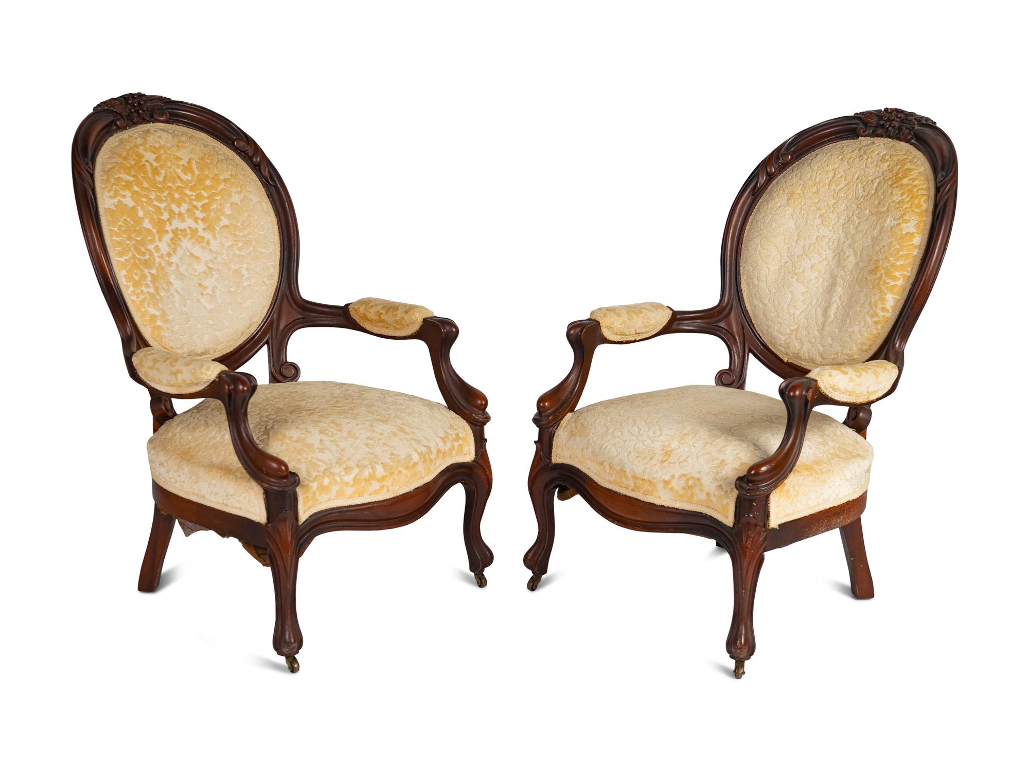 A Pair of Rococo Revival Carved Walnut Fauteuils