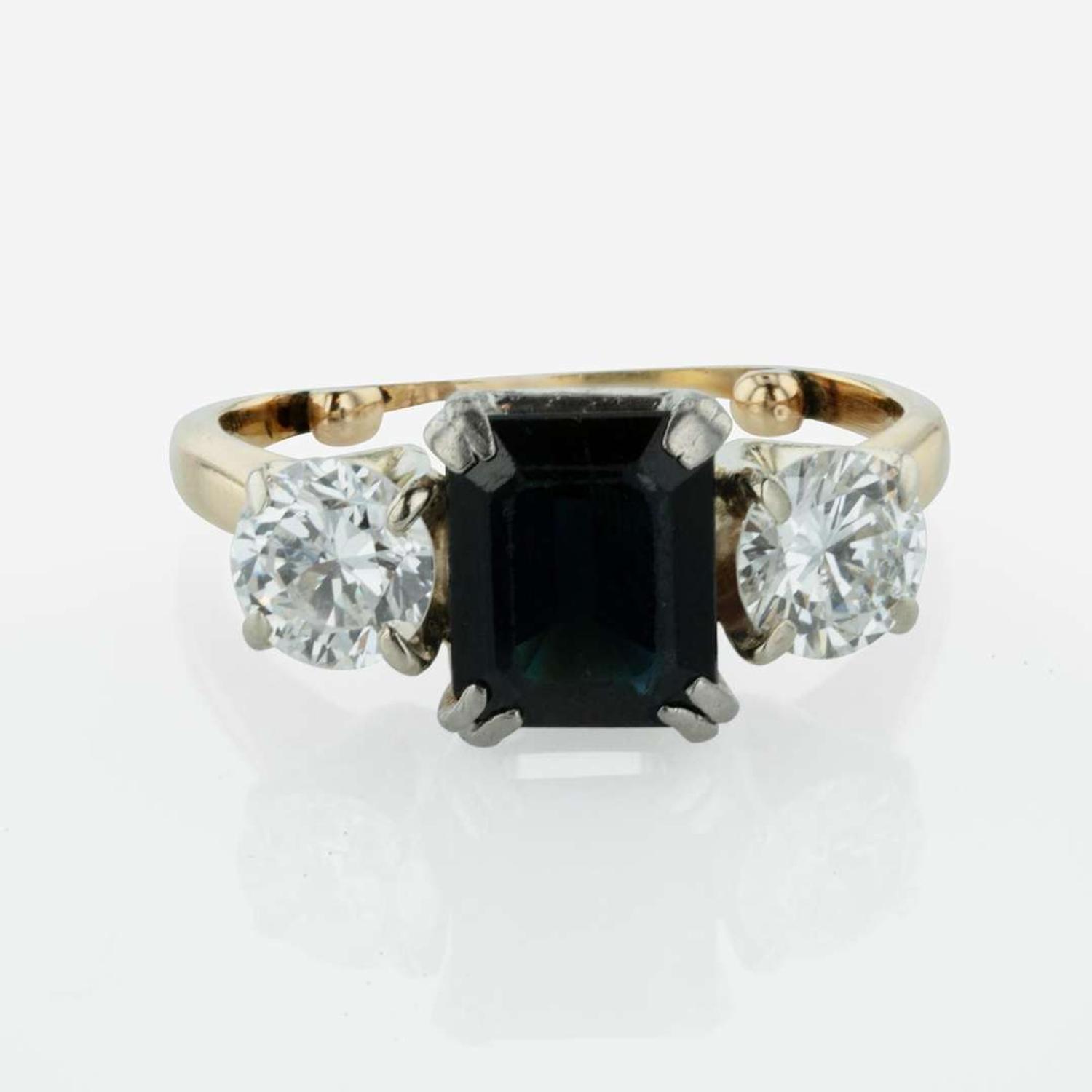 A Three Stone Sapphire and Diamond Ring