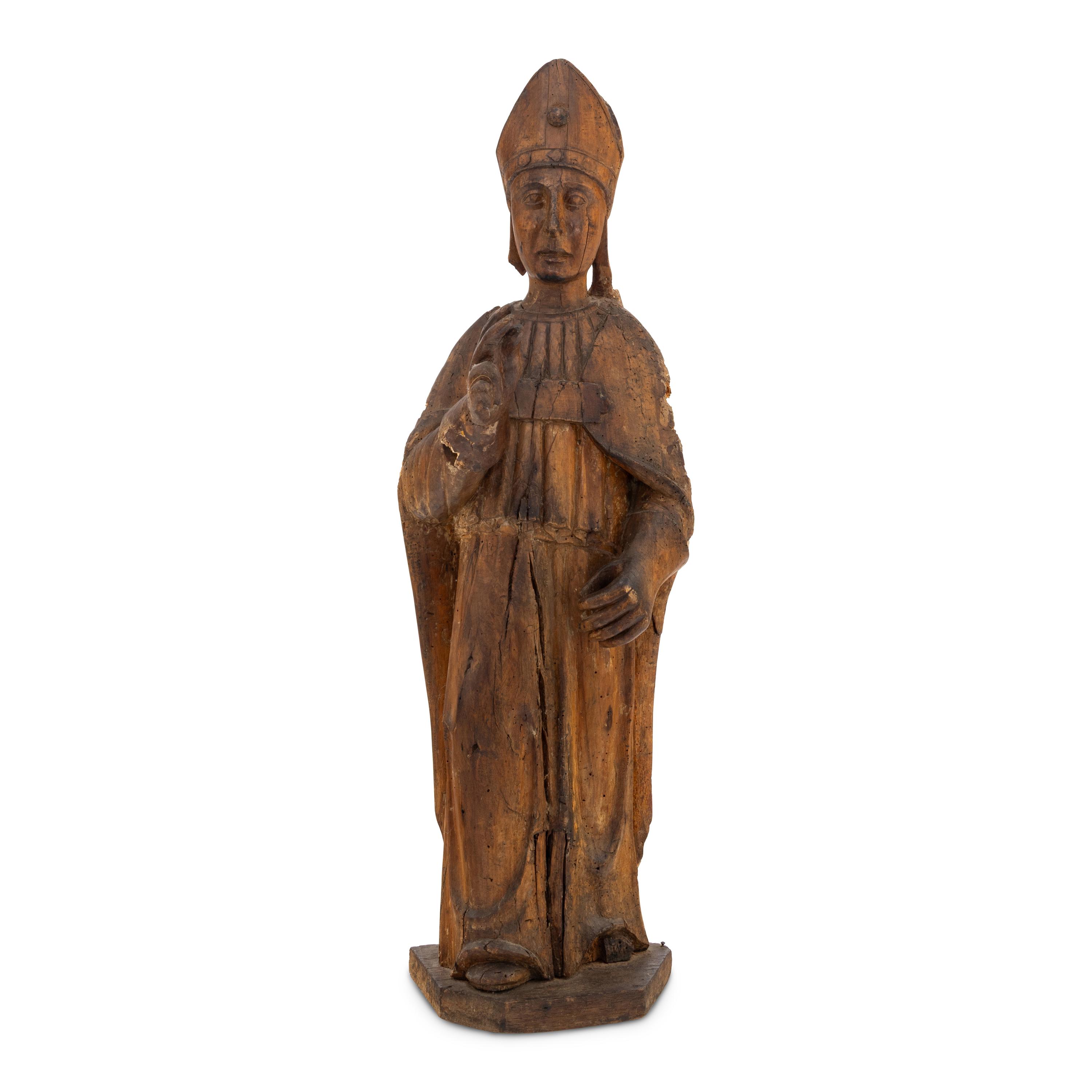 A Carved Walnut Figure of a Bishop