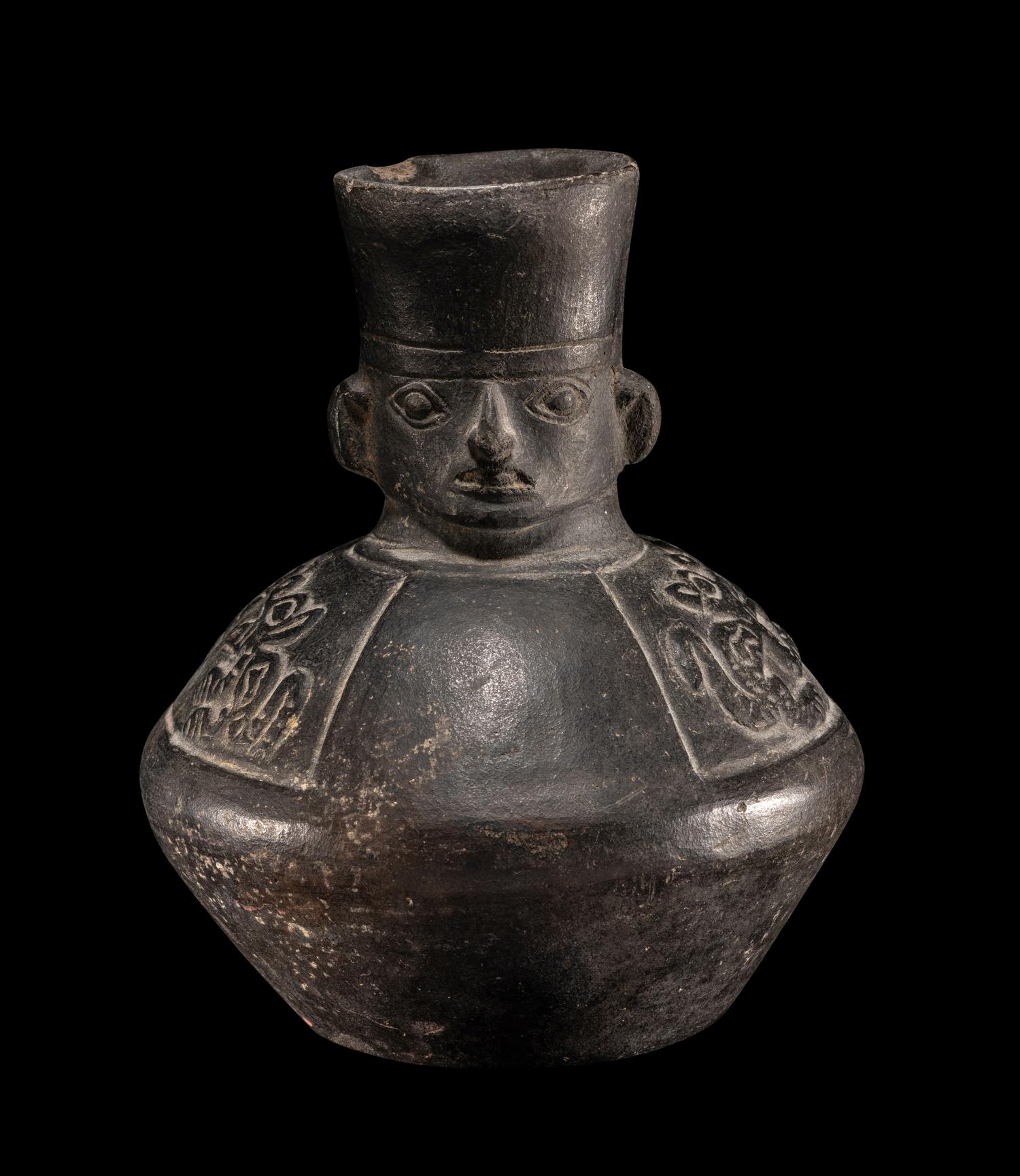 A Chimu Blackware Vessel with Human Face and Animal Motif