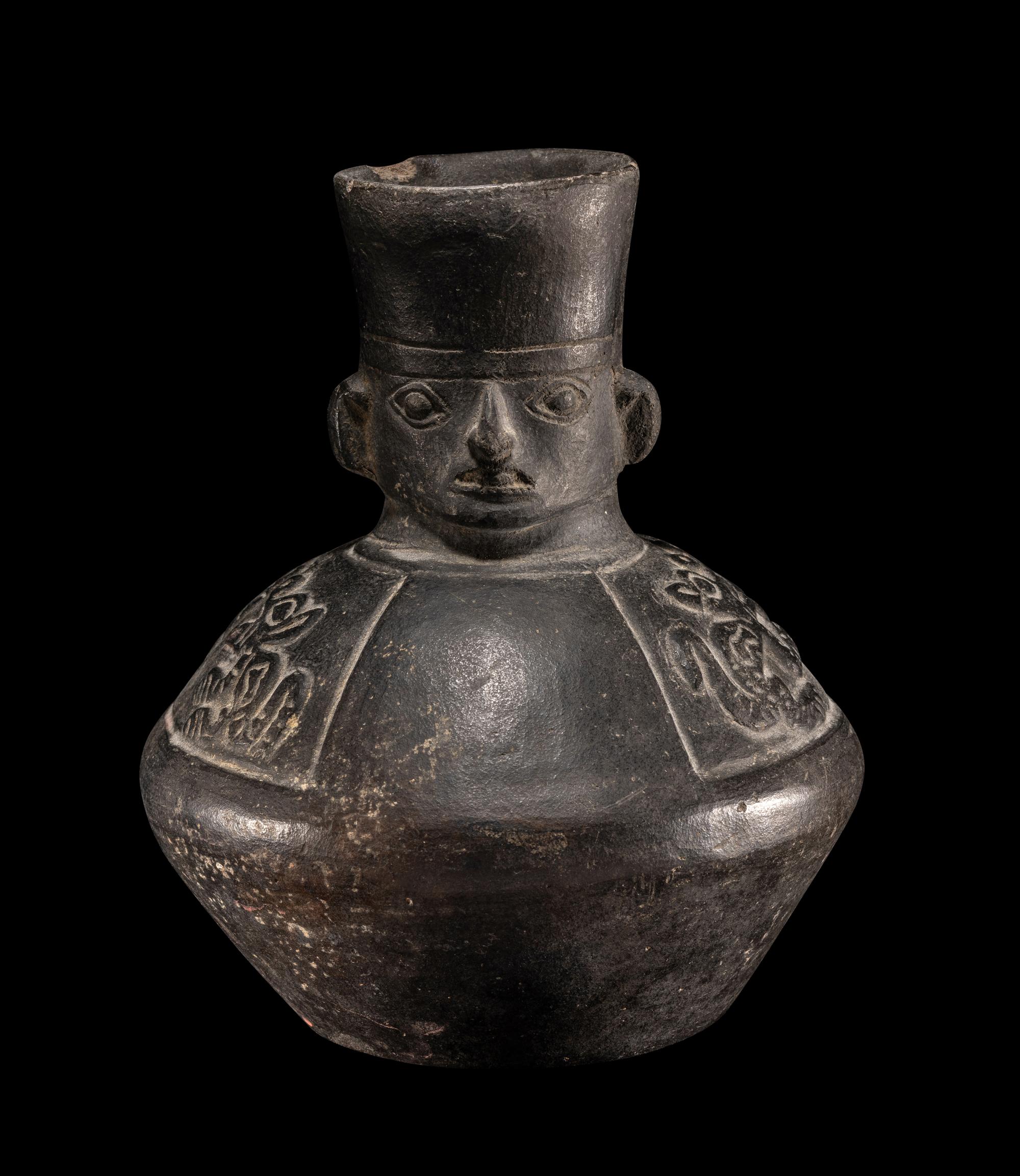 A Chimu Blackware Vessel with Human Face and Animal Motif
