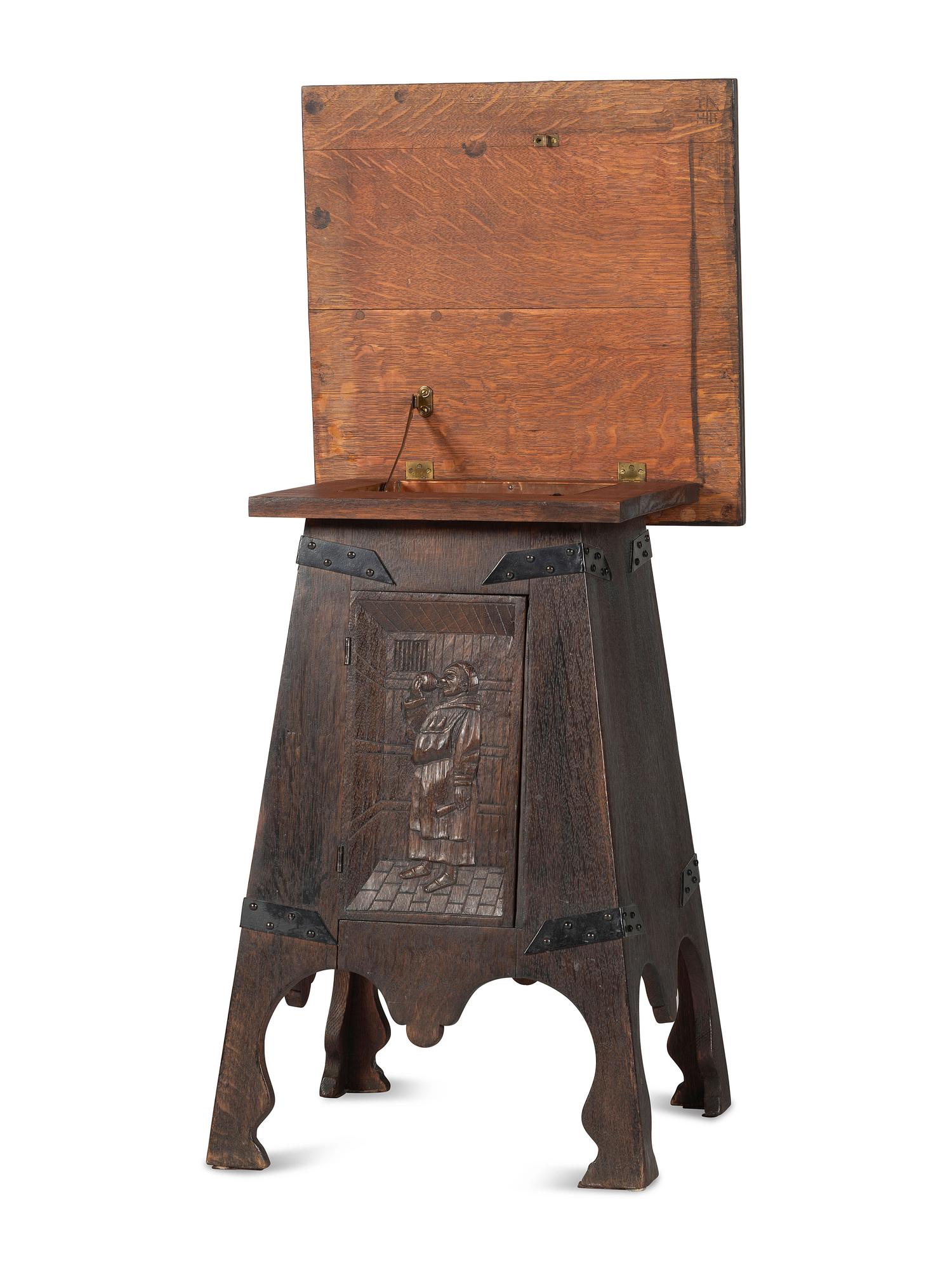 An Arts and Crafts Carved Oak Wine Cellarette