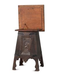 An Arts and Crafts Carved Oak Wine Cellarette
