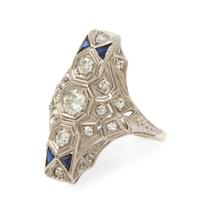 An Art Deco Platinum, 14 Karat White Gold, Diamond and Synthetic Sapphire Ring, 3.80 dwts.
