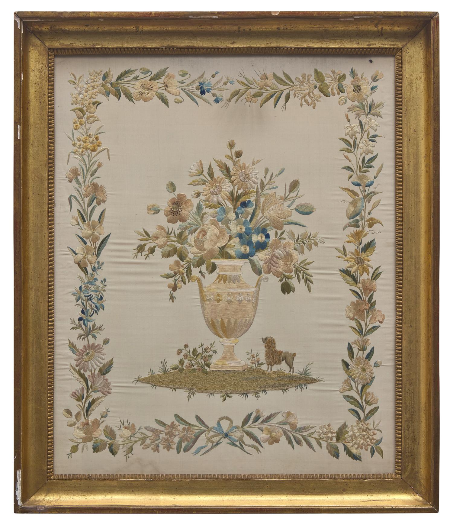 An English Regency Embroidered Silkwork Picture of a Floral Urn with Poodle