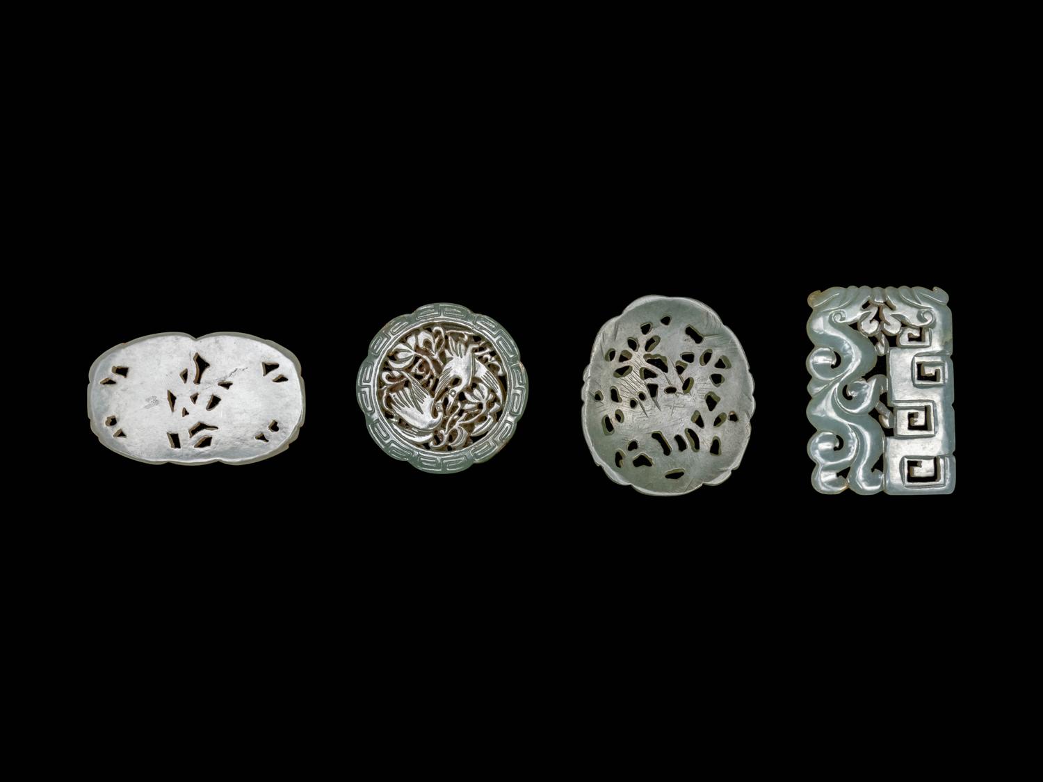 Four Chinese Celadon Jade Carved and Reticulated Pendants