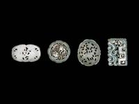 Four Chinese Celadon Jade Carved and Reticulated Pendants