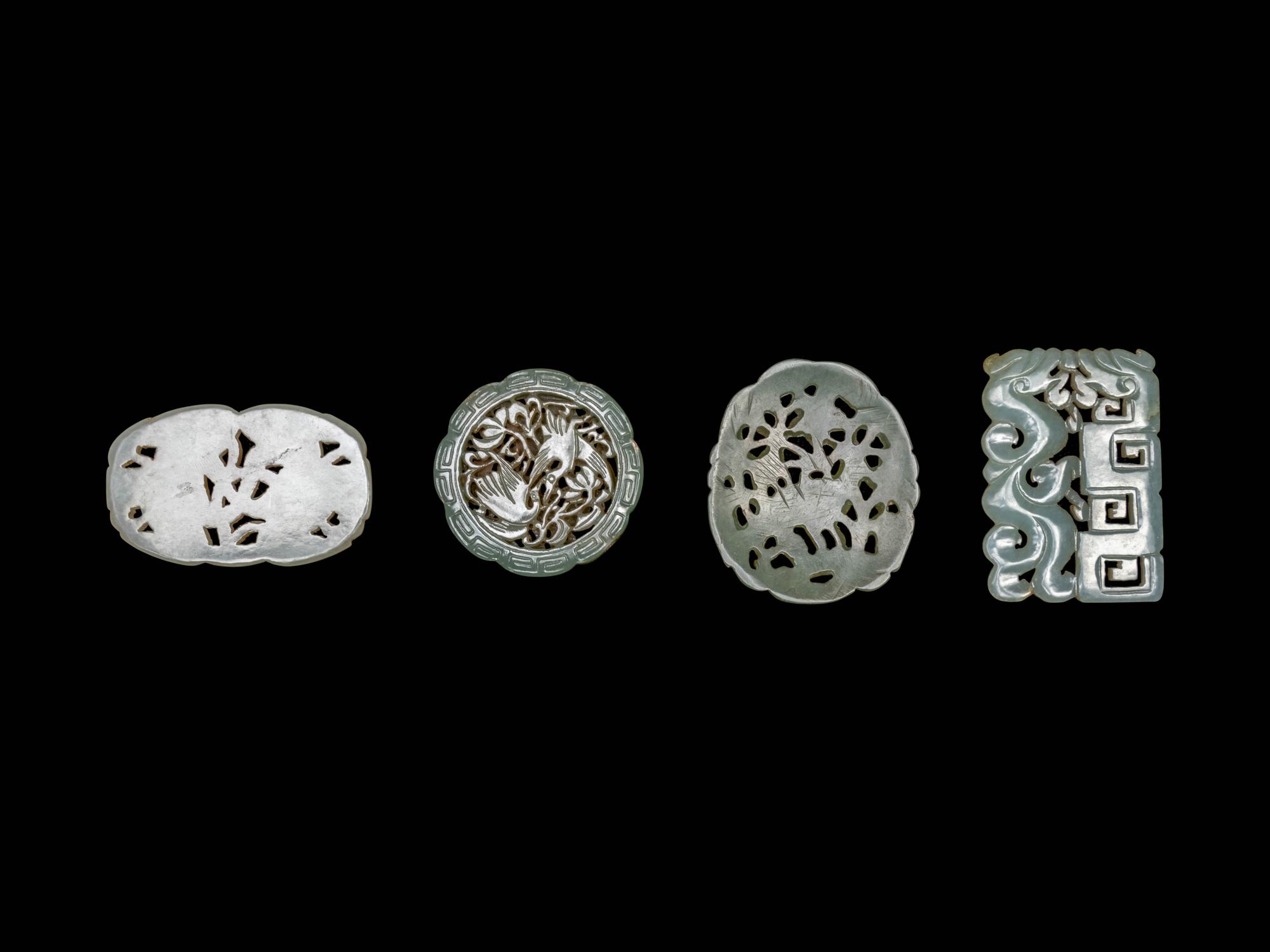 Four Chinese Celadon Jade Carved and Reticulated Pendants