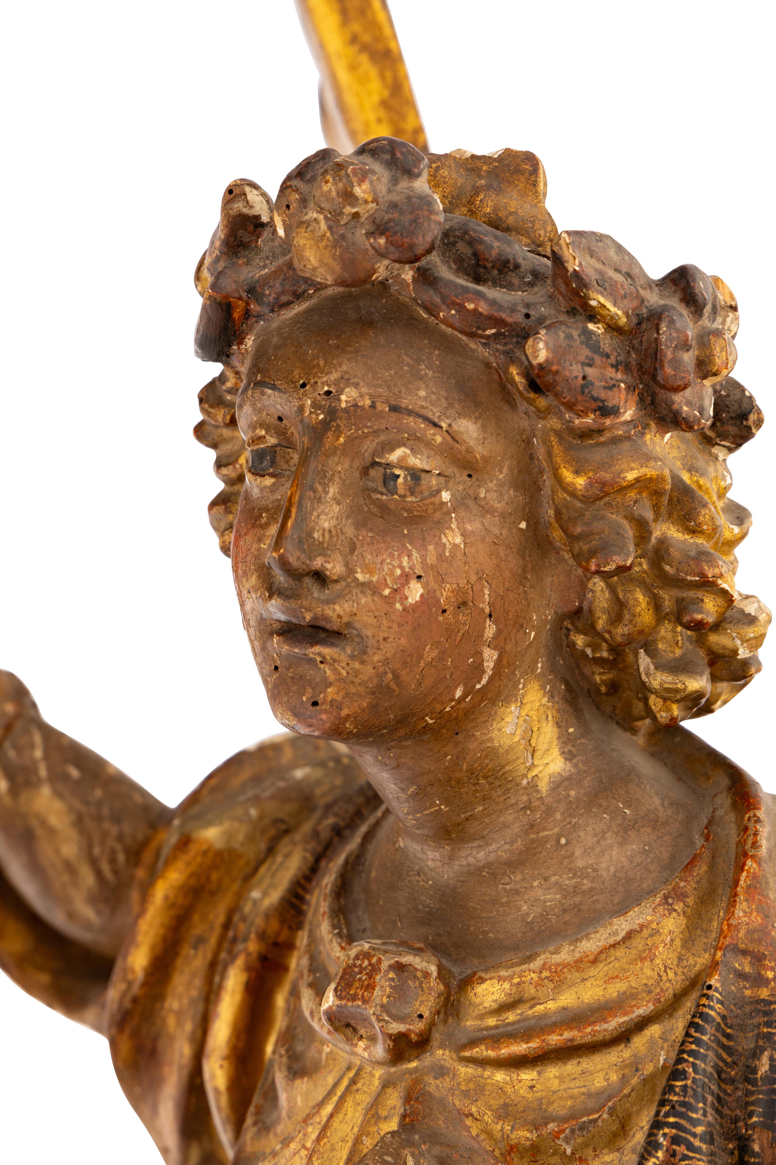 A Pair of Italian Painted and Parcel Gilt Figural Altar Prickets