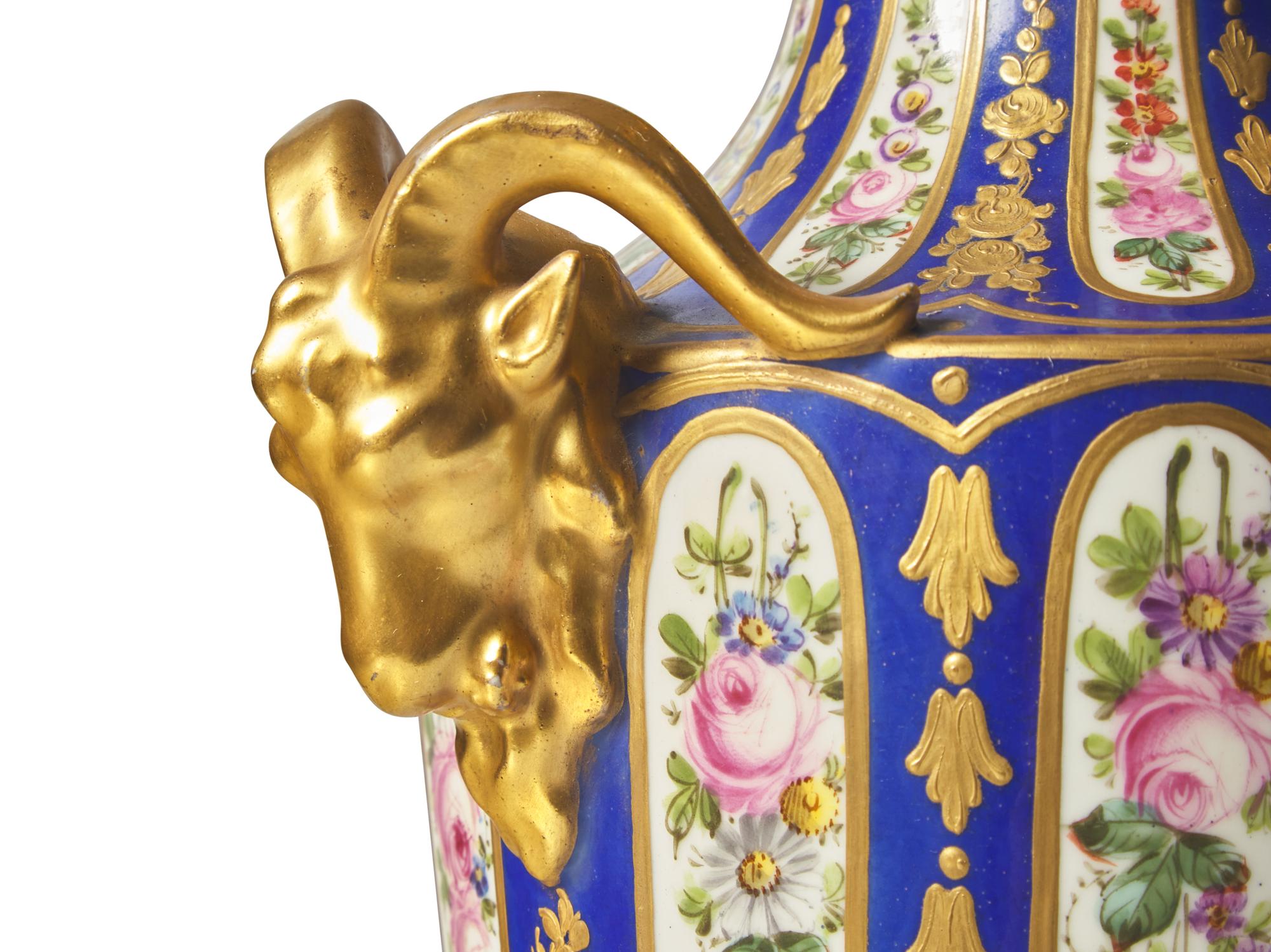 A Pair of Sevres Parcel Gilt, Cobalt and Garland Decorated Porcelain Lidded Urns