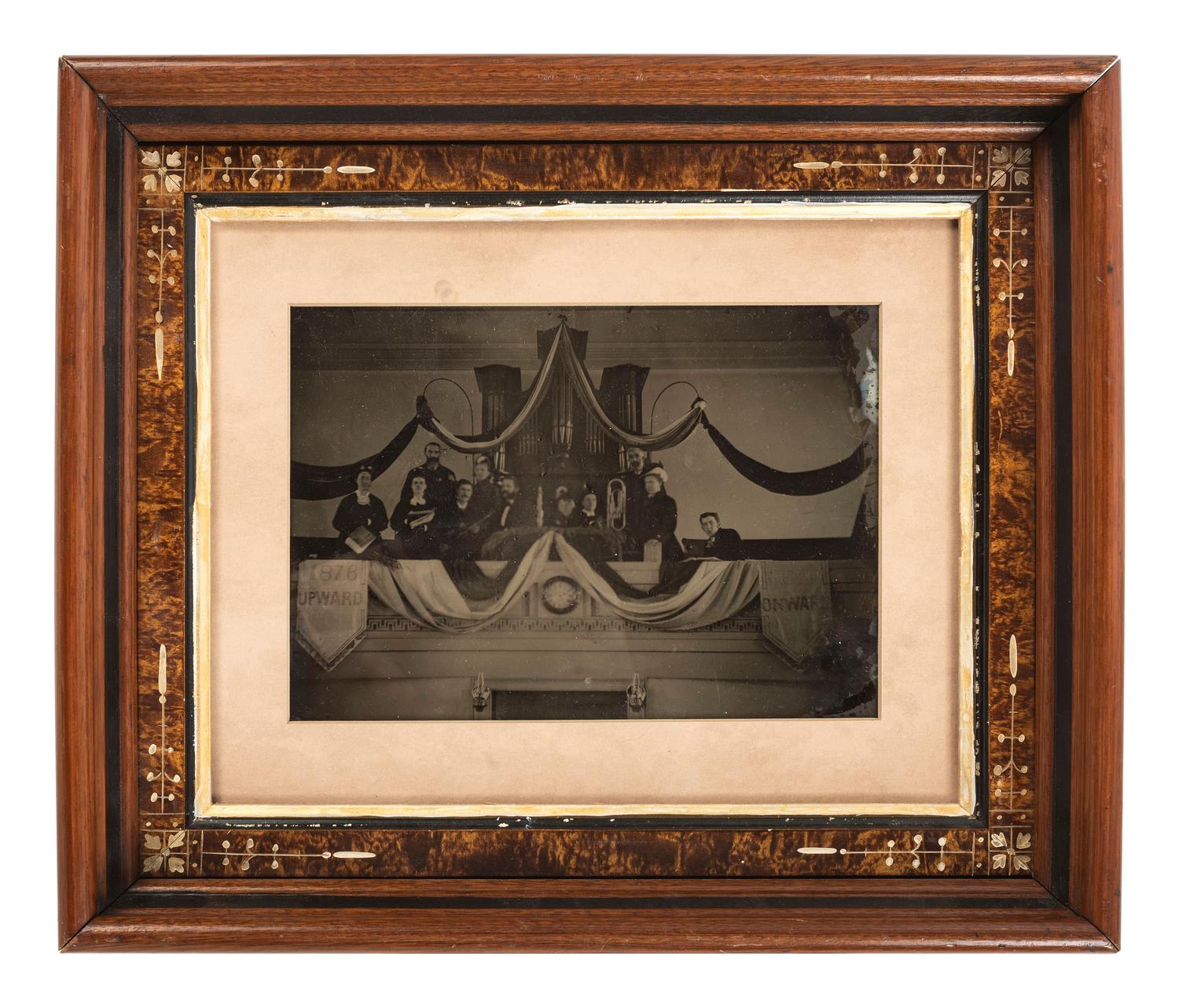 Ambrotypes Upward / Onward . Whole plate ambrotype of a musical group, likely a church band, posed in front of an organ. Ca 1876.