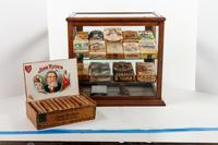 A Collection of Fifteen Tobacco Cartons and a Tobacco Rope in Display Case