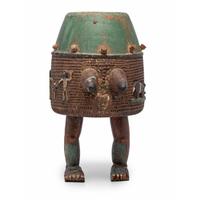 An Ashanti Carved and Gouged Painted Wood Breasted Drum
