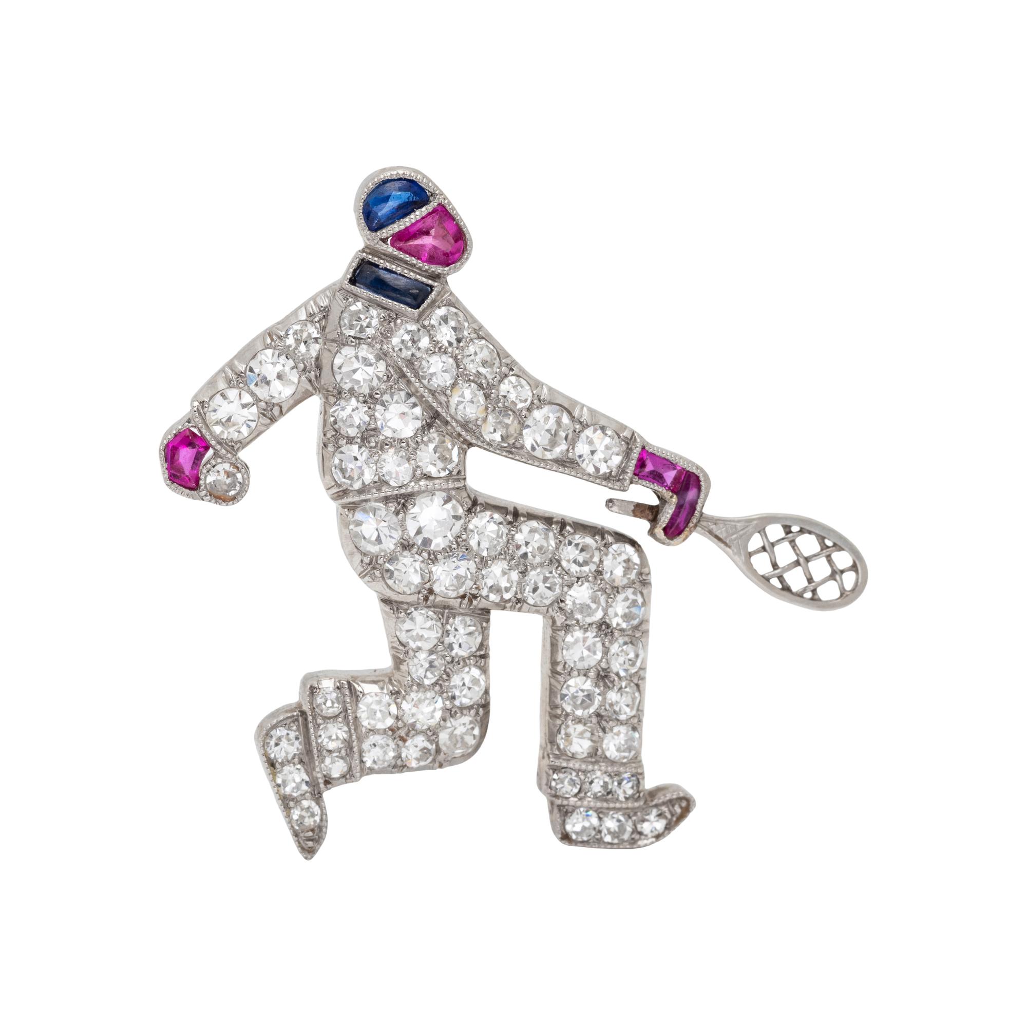 AUSTRIAN, ART DECO, DIAMOND, RUBY AND SAPPHIRE TENNIS PLAYER BROOCH