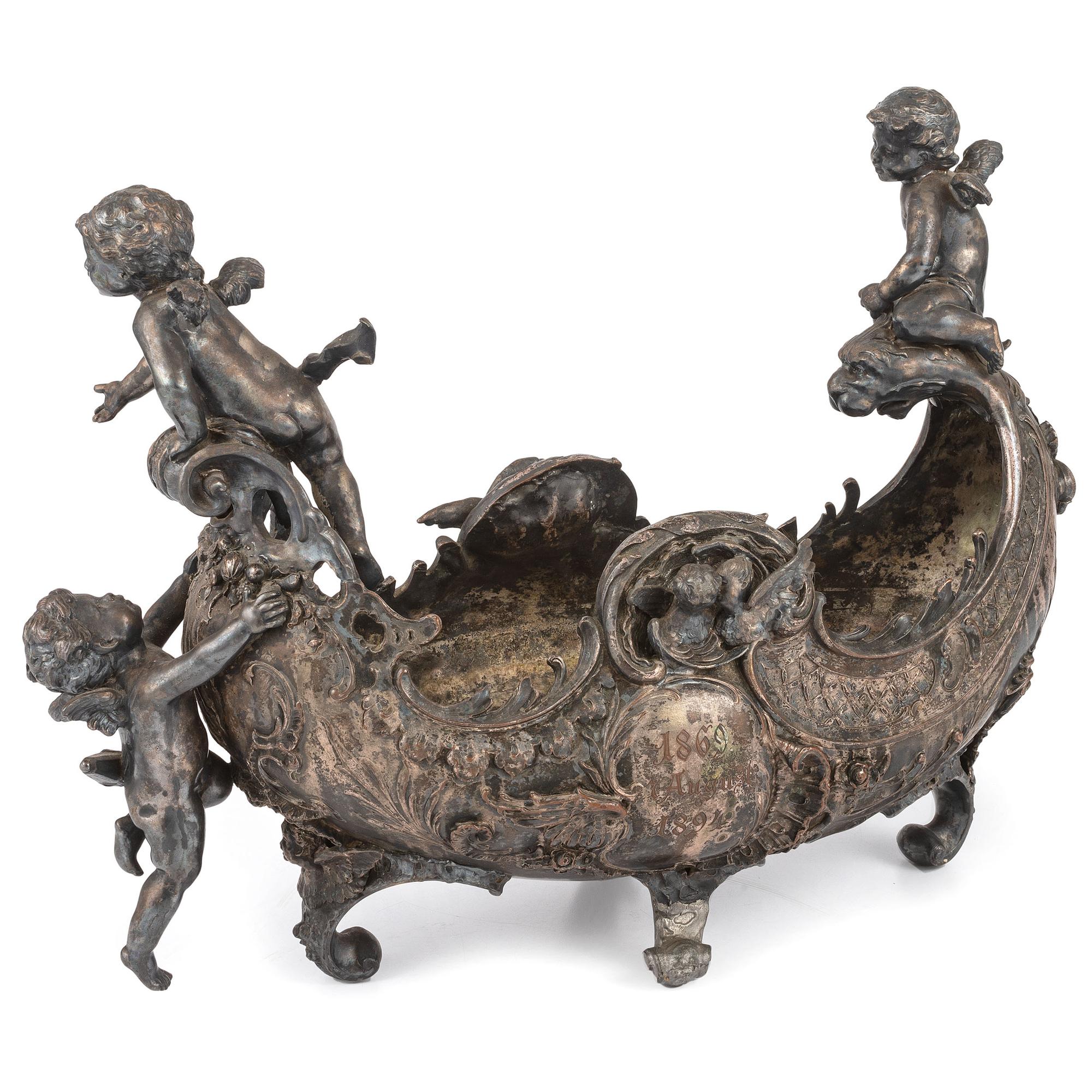 An Ornate Silverplate Centerpiece Bowl of Boat Form with Cherubs