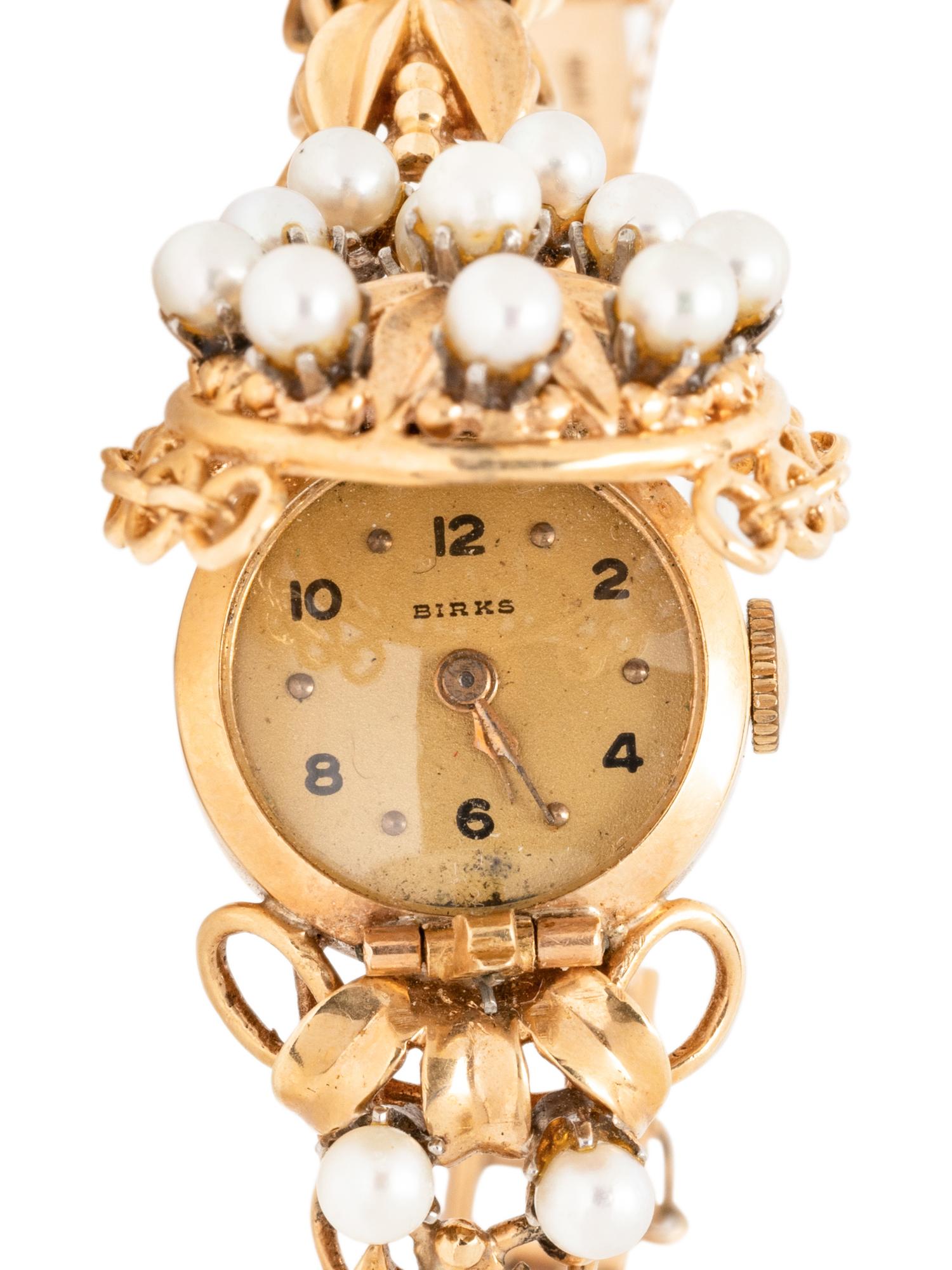BIRKS, YELLOW GOLD AND CULTURED PEARL SURPRISE WATCH