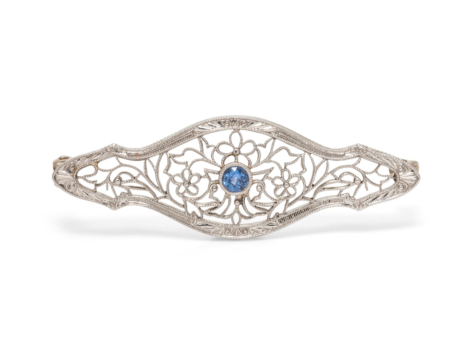 A 14 Karat White Gold and Sapphire Brooch,