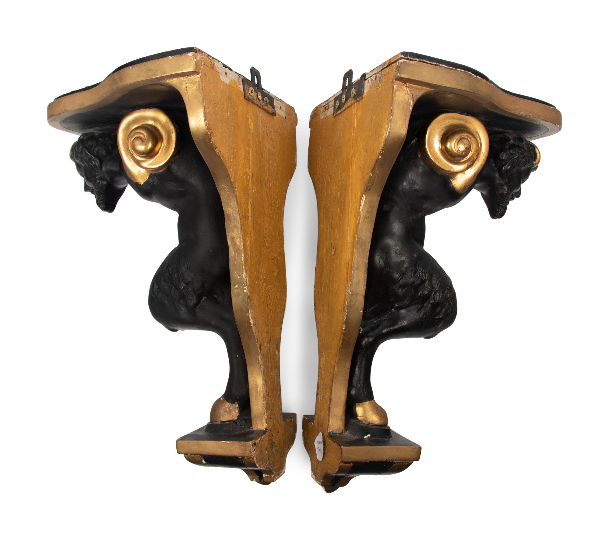 A Pair of Continental Ebonized and Parcel Gilt Wood Figural Brackets