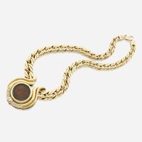 A gold, diamond, and coin necklace