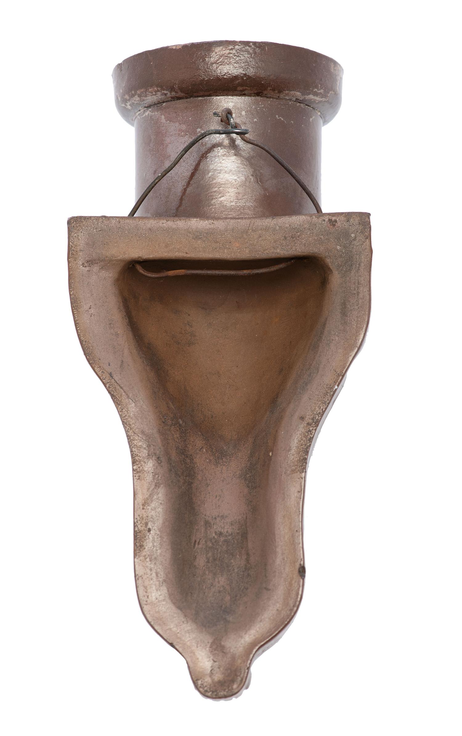 A Glazed Sewer Tile 'Liberty Head' Hanging Match Holder