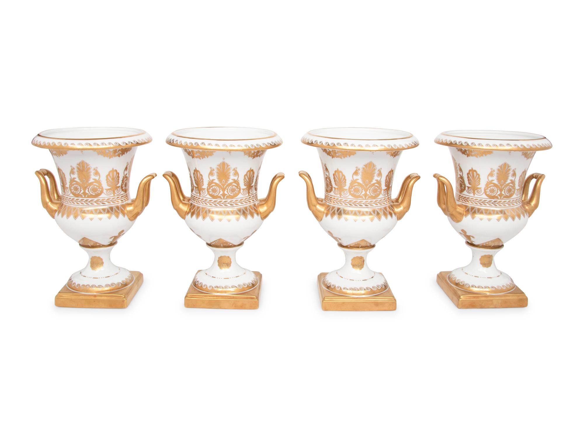 A Set of Four Gilt-Decorated Porcelain Urns