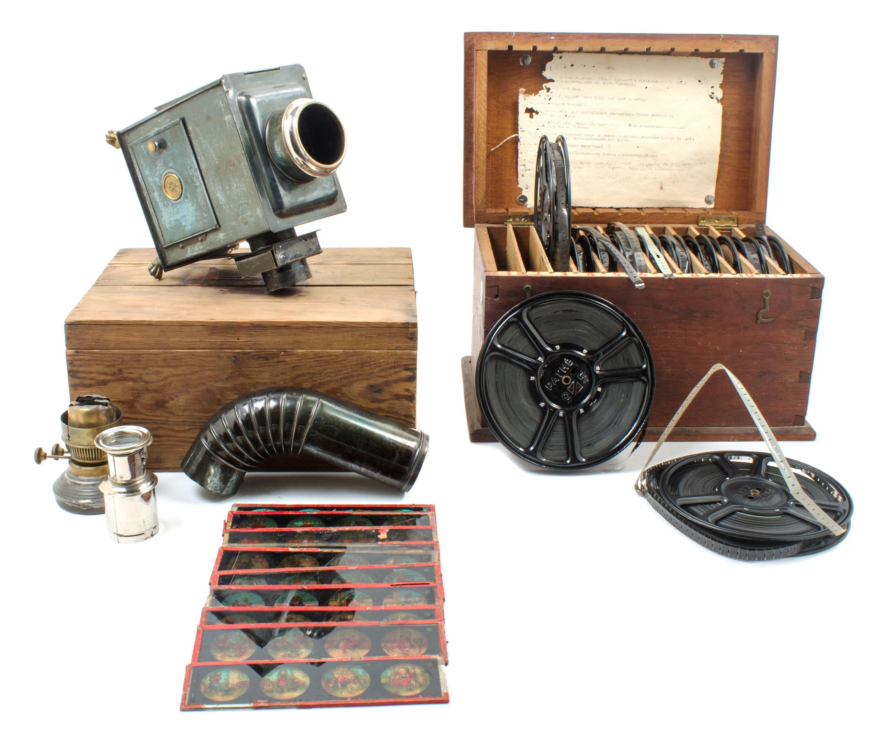 A Brass and Cast Metal Magic Lantern Height of magic lantern 7 1/2 inches.
