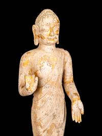 A Chinese Carved Stone Standing Draped Guanyin Figure with Remnants of Gilt on Surface