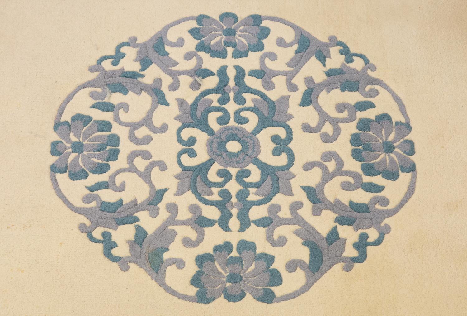 An Indian Blue and Ivory Chinese Style Wool Rug
